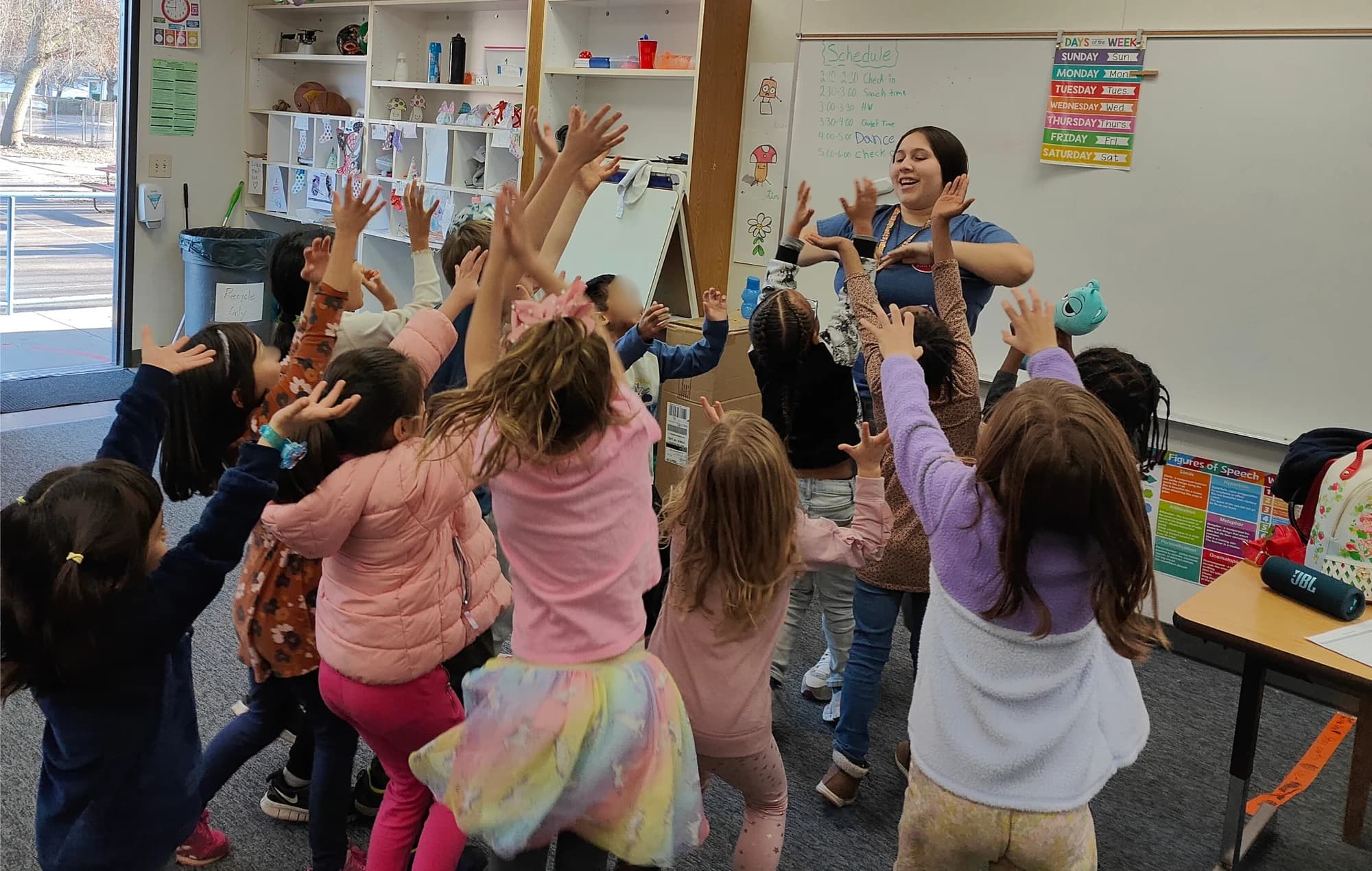 Students raising their hands during a NorCal Arts classroom activity