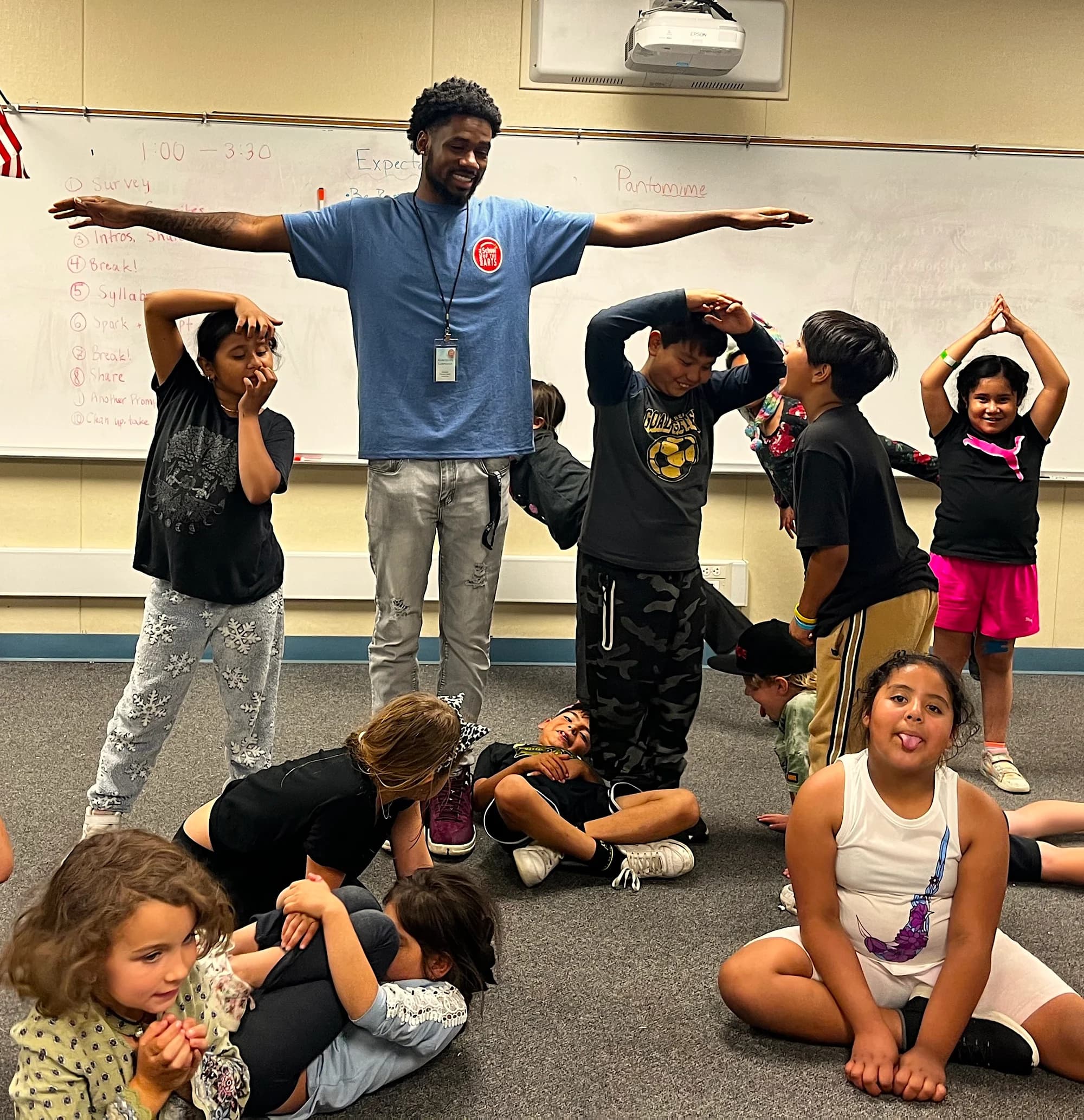 A teaching artist leads students in a creative movement activity