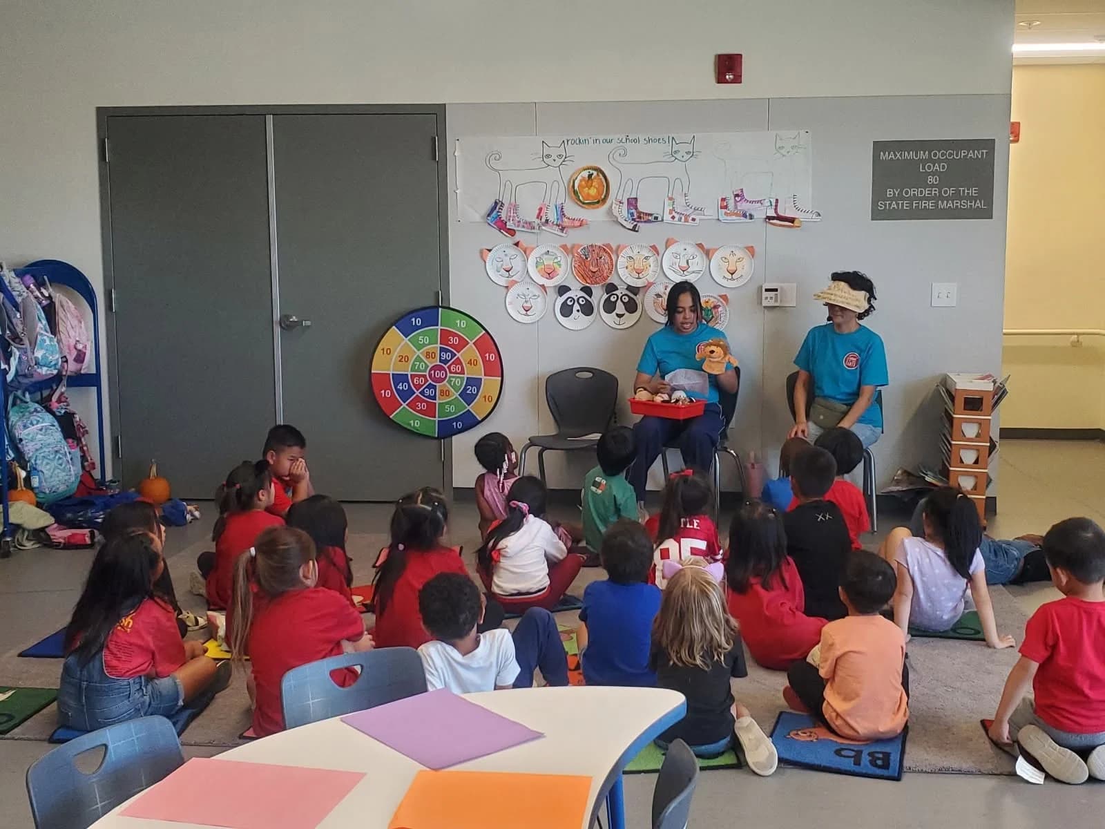 Young students gather for a story with their NorCal Arts teaching artist