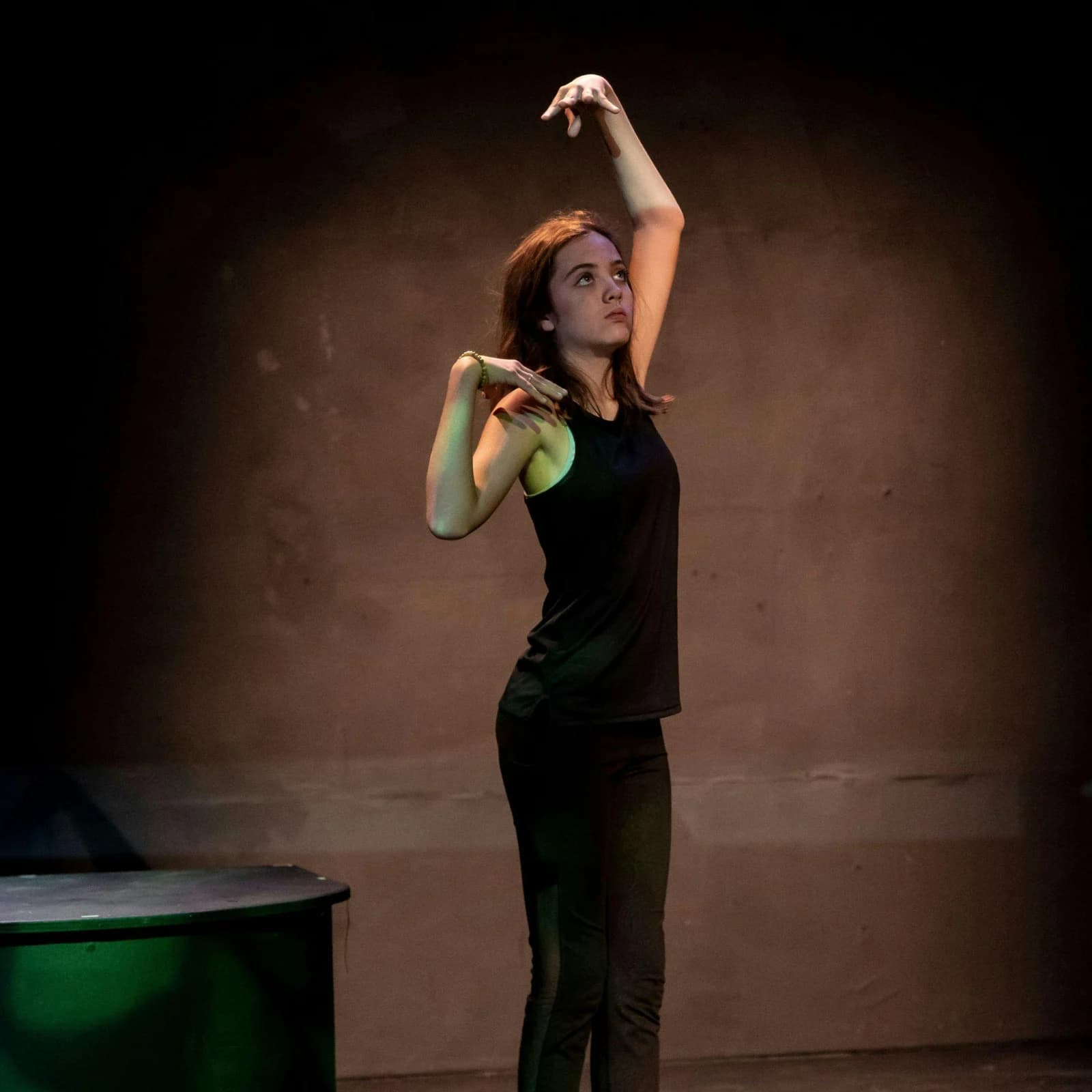 A NorCal Arts performer extending an arm during a stage performance